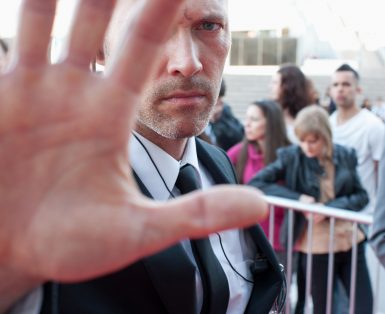 Bodyguard blocking camera
